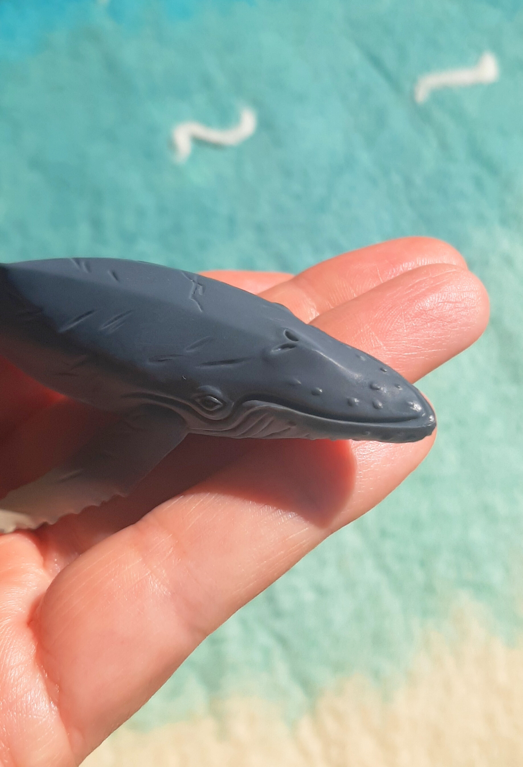 head detail of very realistic lifelike baby humpback whale calf toy figurine