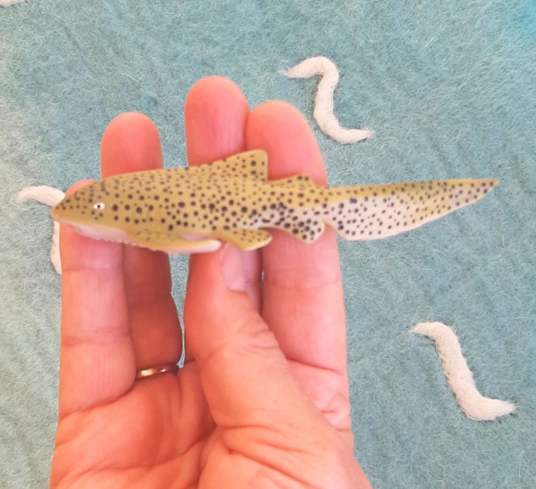 close up detail of realistic zebra shark toy figurine